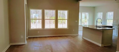 Kitchen with stone countertops, wood-type flooring