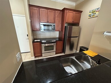 This kitchen features wooden cabinets, stainless s