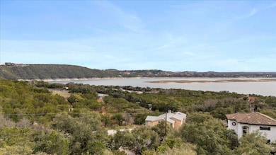 Property view of water featuring a wooded view