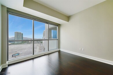 Unfurnished room featuring baseboards, a city view