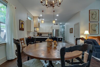 Dining space with an inviting chandelier, baseboar