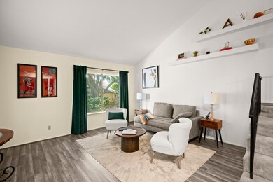 Living room featuring high vaulted ceiling and wo