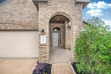 Your guests will enter through this gorgeous archway onto the large, covered front porch.  Recent updates to this home include a sprinkler system, and a new door opening system and shelving in the garage.