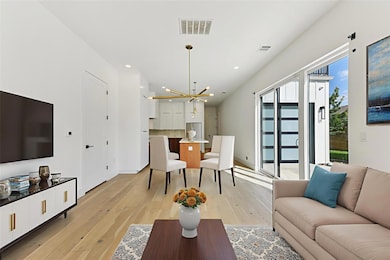 Living area with a chandelier, light wood-type fl
