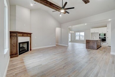 Unfurnished living room with beam ceiling, light w