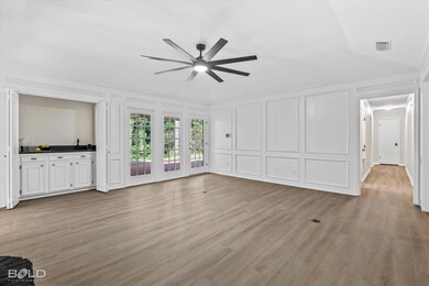 Unfurnished living room with ornamental molding, w