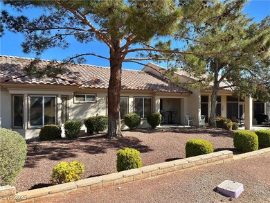 Single story home featuring stucco siding and a ti