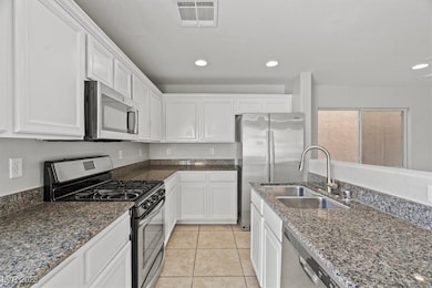 Kitchen featuring appliances with stainless steel