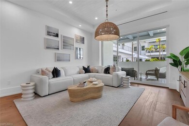 Living room with wood finished floors, recessed li