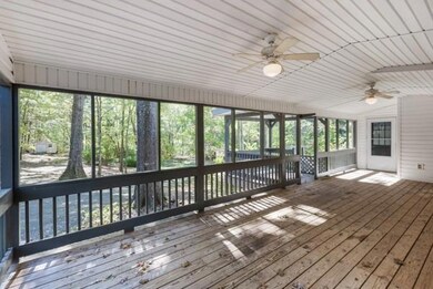 Unfurnished sunroom with a deck and ceiling fan