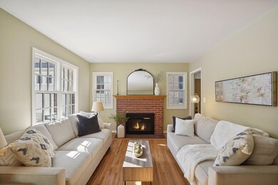 This sun filled living room welcomes you with it's wood burning fireplace and original oak floors.