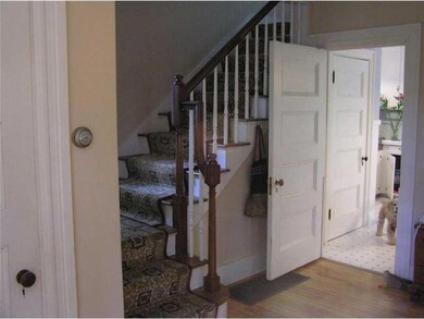 Living Room. Wide stairhall to...