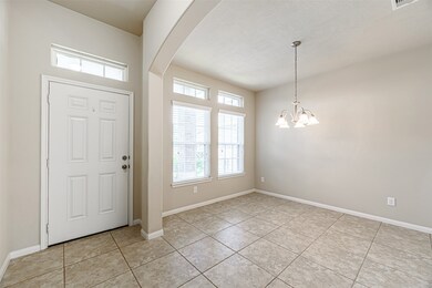 As you enter the foyer you are greeted by this very sizeable formal dining room with 2 large windows and transoms above that allow natural light to stream into the room.