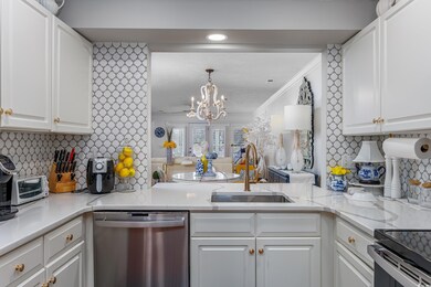 Kitchen featuring a chandelier, a peninsula, stain