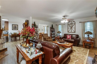 Living room with plenty of natural light, ceiling fan, and wood finished floors