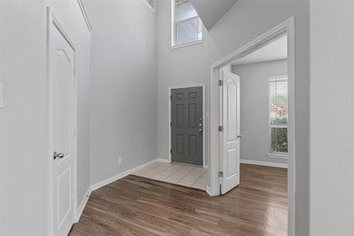 Entryway featuring wood finished floors and baseb