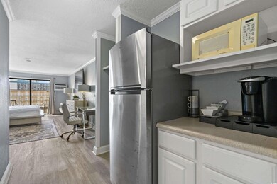 Kitchen with crown molding, light wood-style floor