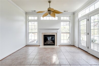 Unfurnished living room with ornamental molding, a