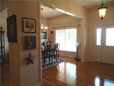 A large foyer opens to the formal dining room and great room. The gleaming hardwood floors continue throughout the living areas including the master bedroom. 