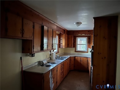Kitchen featuring light countertops and brown cabinets