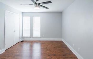 Unfurnished bedroom with ceiling fan, a closet, wo