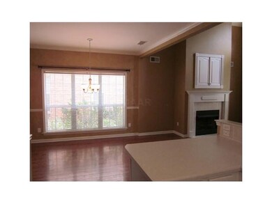 The dining room has hardwood flooring and a large 