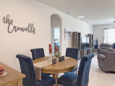 Dining room w Living room in background and view if hall to primary bedroom. Ceramic tile flooring, 51/4”baseboards