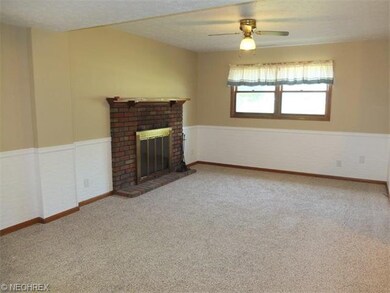 Family room with fireplace and new carpet.