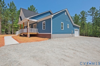 View of side of property featuring a porch, gravel driveway, and roof with shingles
