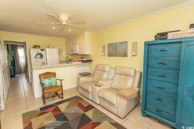 Living area with crown molding, light tile patterned flooring, ceiling fan, and recessed lighting