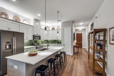 The modern kitchen has white cabinetry, an abundan