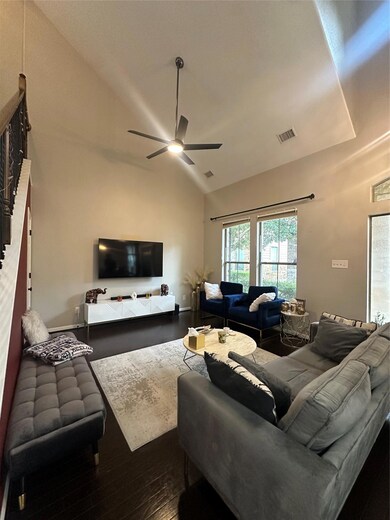 Living area featuring a ceiling fan, hardwood / w