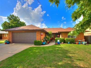 Single story home featuring brick siding, an attached garage, concrete driveway, and roof with shingles