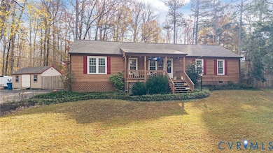 View of front of home featuring crawl space, a storage shed, a porch, and roof with shingles