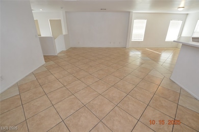 Unfurnished room with light tile patterned floors and baseboards