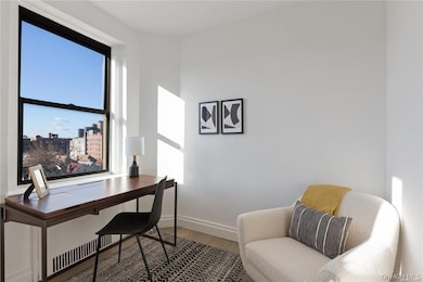 Office area with wood finished floors and a view of city