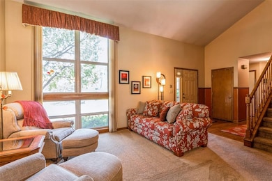 Foyer with Vaulted Ceiling and Open Staircase