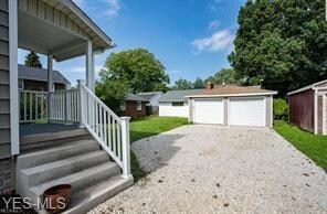 2 car garage features new roof, siding and overhea