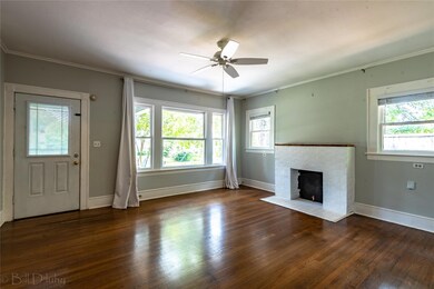 Unfurnished living room featuring dark hardwood / 