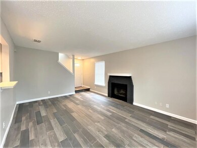 Unfurnished living room with wood finished floors