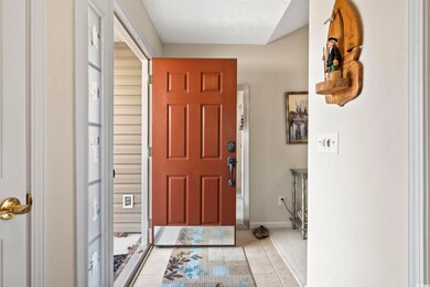 Tiled entryway with a textured ceiling
