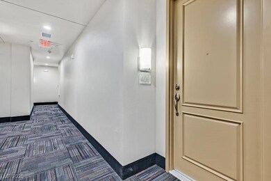 Hall featuring dark carpet and baseboards