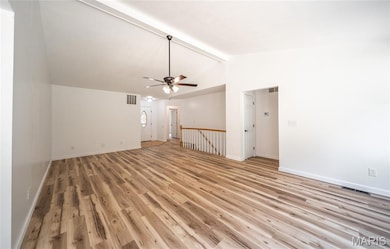 Unfurnished living room with light wood-style flooring and a ceiling fan