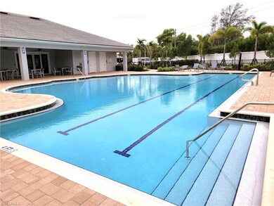 Community pool with a patio, fence, and a ceiling 