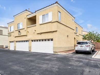 View of side of home with an attached garage, a ti
