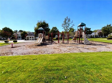Community playground with a lawn and a residential view