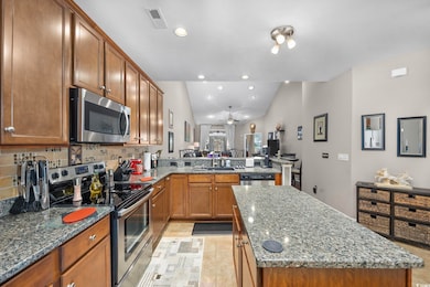 Kitchen with sink, vaulted ceiling, appliances wit