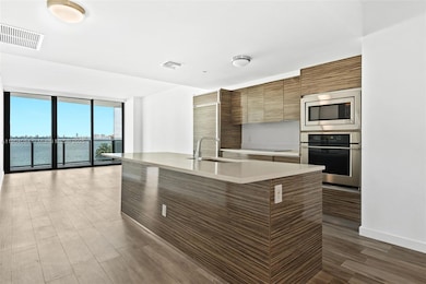 Modern kitchen with stainless steel appliances overlooking the bay.