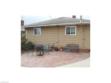 Rear (north) exterior and stamped, concrete patio.