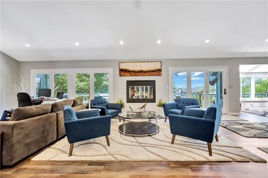 Great room with gas fireplace and view of the lake